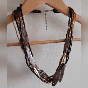 Multi Strand Chunky Necklace with Shell and Stacked Wooden Beads.